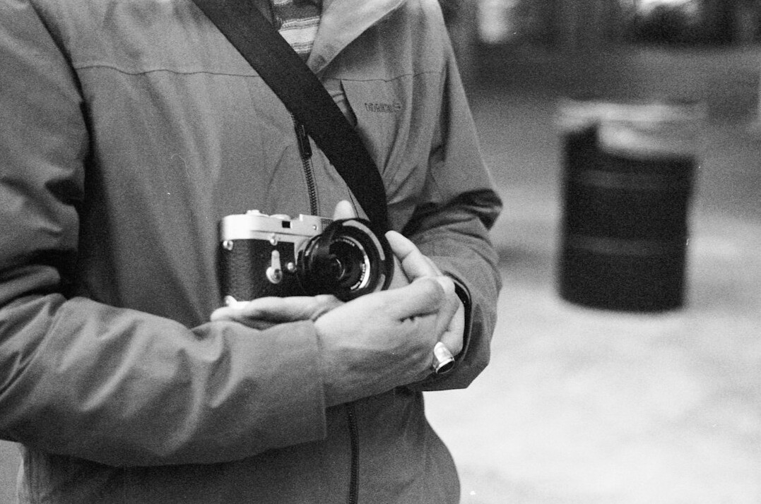 Portrait of a documentary photographer holding a camera